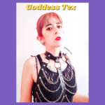 Indiecammodels FinDom cam model Goddess Tex IndieCamFans posing in a black top with chains with a longing but stern look on her face.