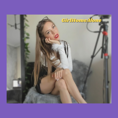 Indiecammodels Girl Next Door Cam Model GirlHomeAlone on her cell phone with her long blonde hair flowing down to her hips. She is sitting with her long legs crossed and her head cocked to one side with her red lipstick painted lips parted.