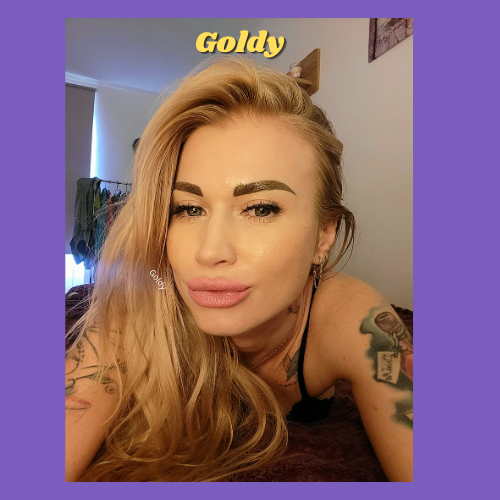 IndieCamModels Girl Next Door Cam Model Goldy IndieCamFans pursing her pink lips with her blonde hair off to one side.