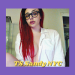 IndieCamModels trans cam model TS Sandy NYC IndieCamFans is sitting in a white button down looking down at the camera over her glasses with her long red hair covering her one exposed breast.